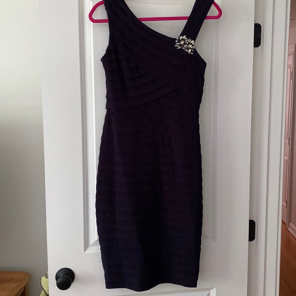 Ladies cocktail dress. Knee length. Has rhinestone decoration sewn into dress.